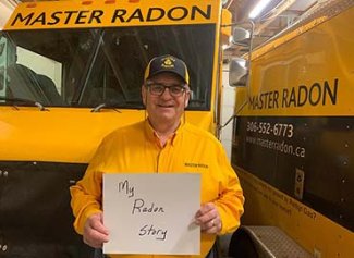 Frank holding up a sign infront of trucks